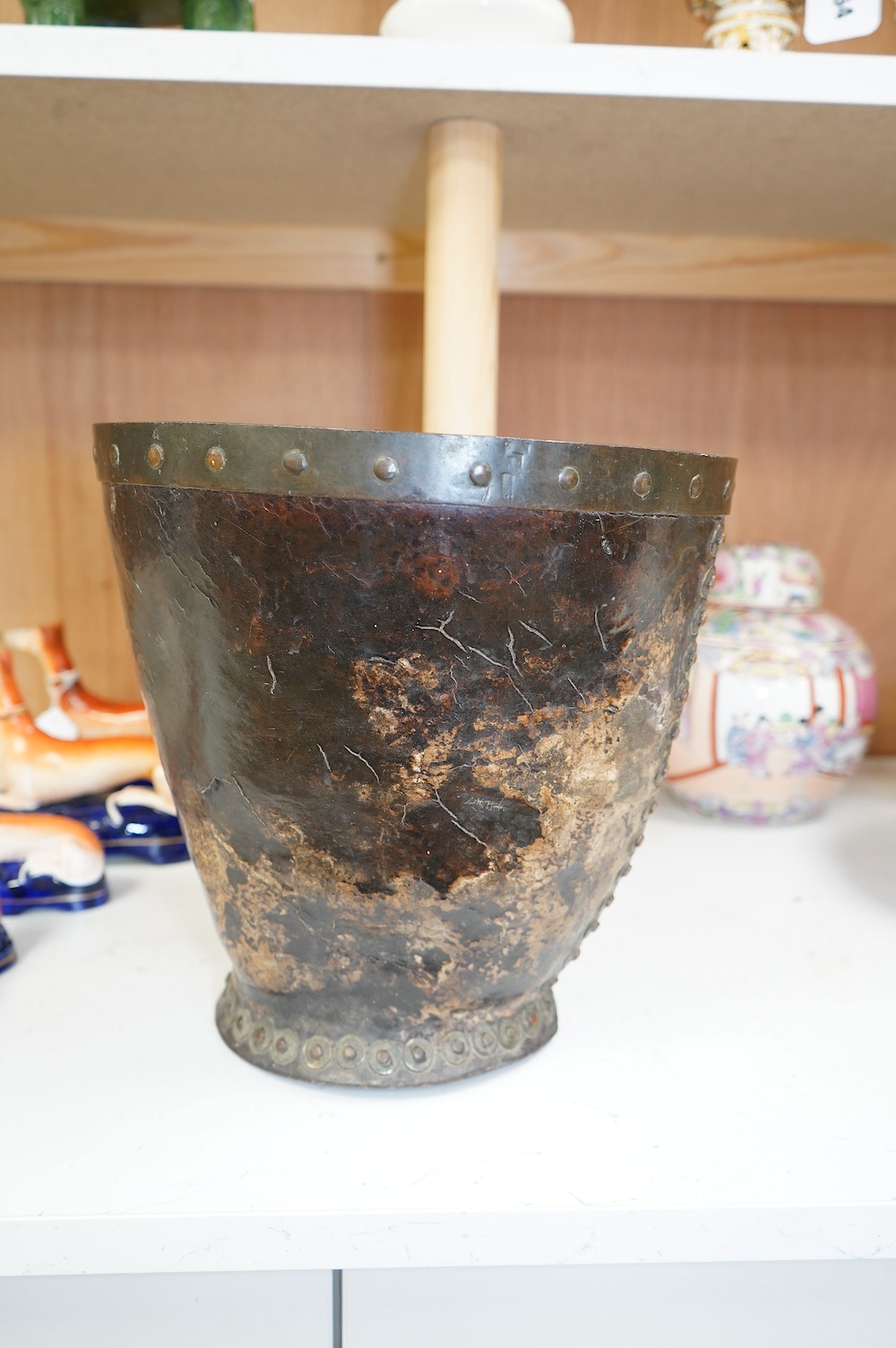 A Georgian mounted leather fire bucket (waste paper bin), 27cm high. Condition - fair